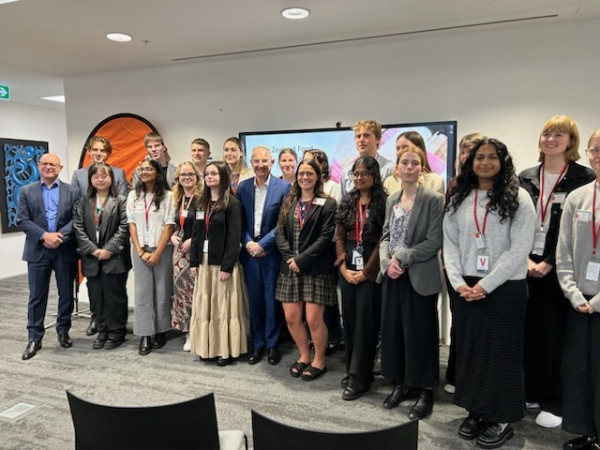 19 interns stood in front of a wall 